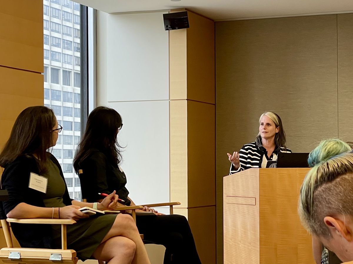 Johanna Dunaway speaking at a podium to a seated audience