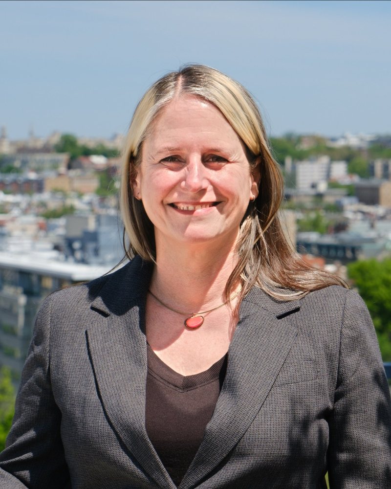 Johanna Dunaway on a rooftop with Washington, D.C. behind her